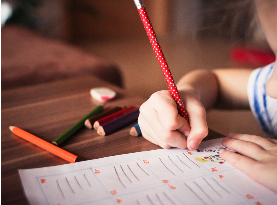 Child studying for 11 plus exam at desk